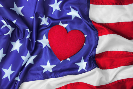 Red felt heart on American flag. USA holidayの写真素材