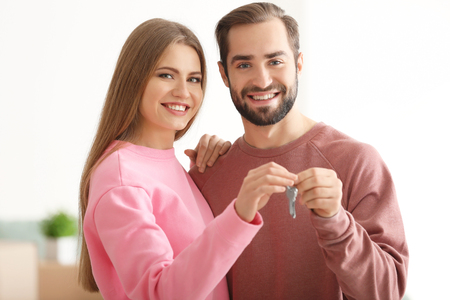 Happy owners holding keys of their new house, indoorsの写真素材