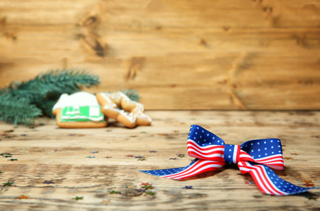 American flag bow and confetti on wooden table. USA holidayの写真素材