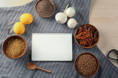 Notebook and products on apron. Cooking classes compositionの写真素材