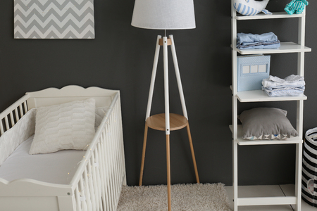 Children's room interior with crib and shelving unitの写真素材
