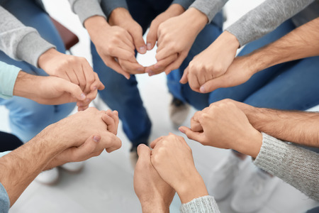 People holding hands together, closeup. Group therapy