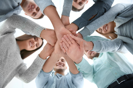 People putting hands together, view from below. Group therapyの写真素材