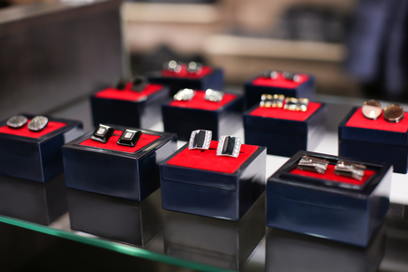 Boxes with cufflinks on shelf in boutiqueの写真素材