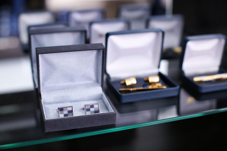 Boxes with cufflinks on shelf in boutiqueの写真素材