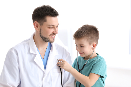 Children's doctor with little boy in hospitalの写真素材