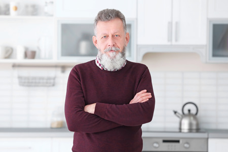 Portrait of mature man in casual clothes indoorsの写真素材
