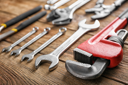 Plumber's tools on wooden backgroundの写真素材