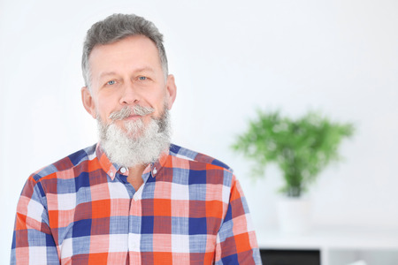 Portrait of mature man in casual clothes indoors