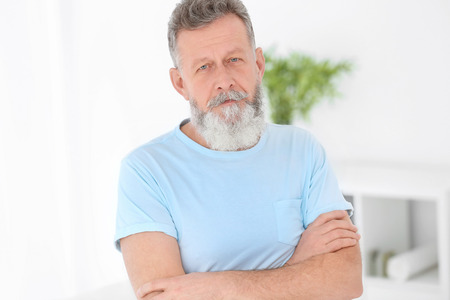 Portrait of mature man in casual clothes indoorsの写真素材