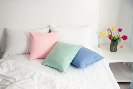 Comfortable bed in light room interiorの写真素材