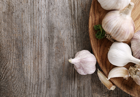 Plate with fresh garlic on wooden tableの写真素材