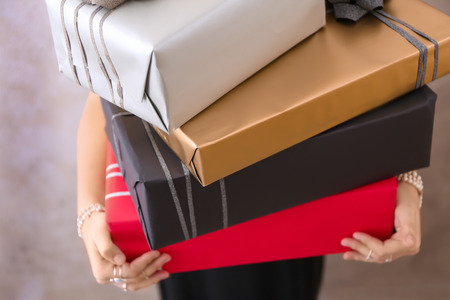 Young woman holding gift boxes, closeupの写真素材