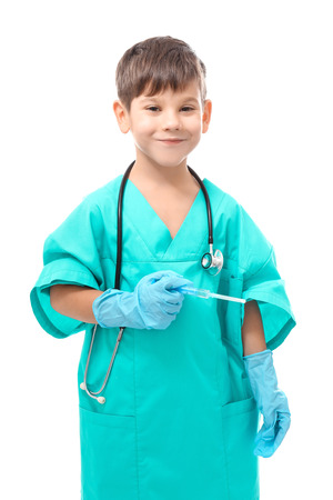 Cute little boy in doctor uniform with syringe on white backgroundの写真素材