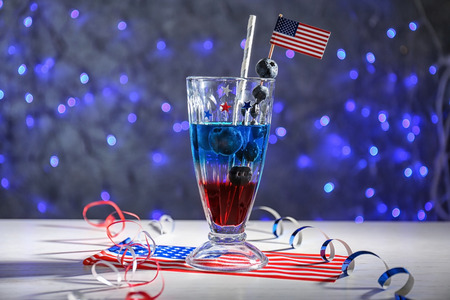 Layered cocktail in colors of American flag on table against blurred backgroundの写真素材