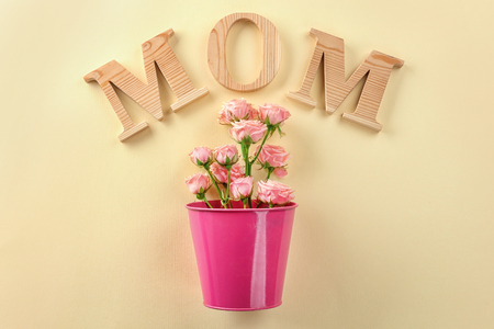 Word "Mom" and roses on light background. Mother's day celebrationの写真素材