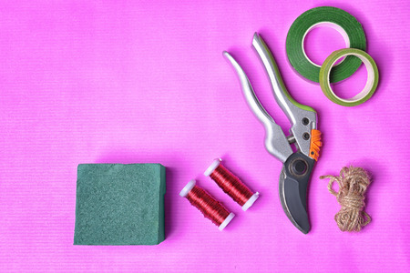Florist equipment on color background