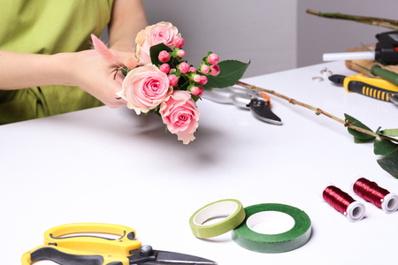 Female florist making beautiful bouquet in flower shopの写真素材