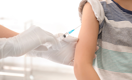 Doctor vaccinating little child in clinic, closeupの写真素材