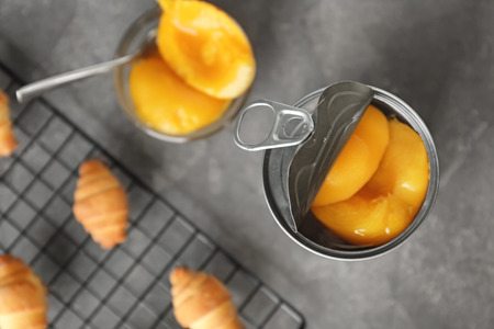 Can with pickled apricots on tableの写真素材