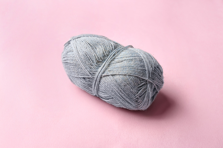 Grey knitting thread on color backgroundの写真素材