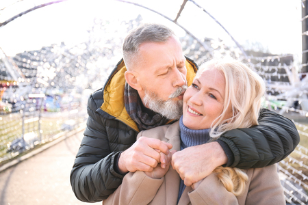 Happy mature couple hugging outdoorsの写真素材