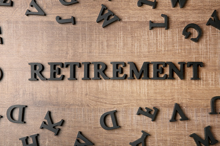 Word "Retirement" on wooden background. Pension planningの写真素材