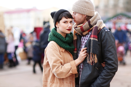 Cute young couple in warm clothes outdoorsの写真素材