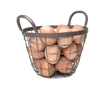 Basket with fresh raw potatoes on white backgroundの写真素材