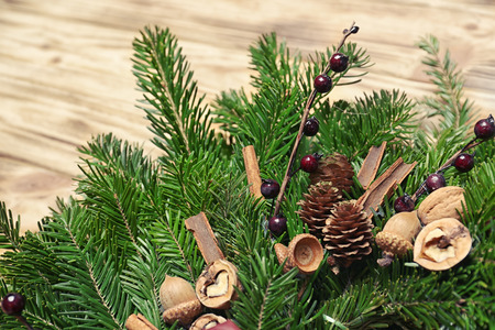 Beautiful Christmas wreath made by professional florist on wooden background, closeupの写真素材