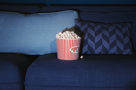 Popcorn on comfortable couch, closeup. Home cinemaの写真素材