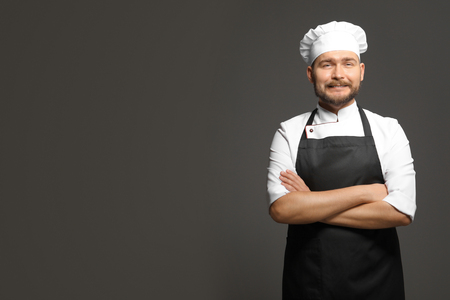 Handsome male chef on dark backgroundの写真素材