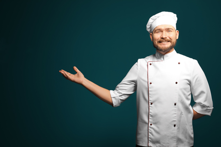 Handsome male chef on color backgroundの写真素材