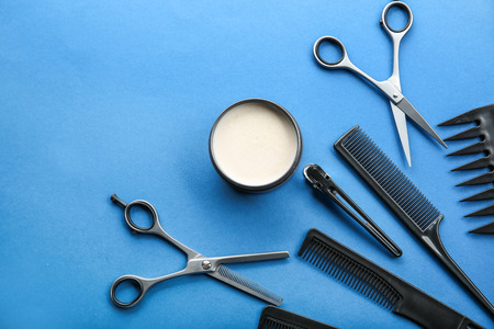Professional hairdresser's tools and clay for hair on color backgroundの写真素材