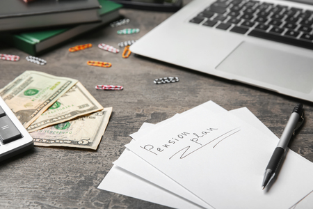 Sheet of paper with text "Pension plan" on tableの写真素材