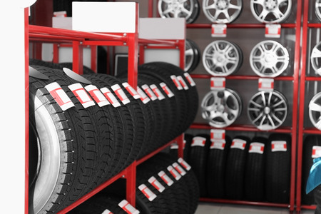 Stand with car tires in automobile store