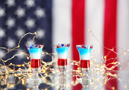 Layered patriotic drinks against blurred American flagの写真素材