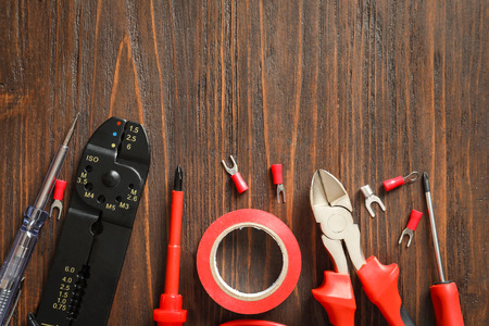 Different electrical tools on wooden background