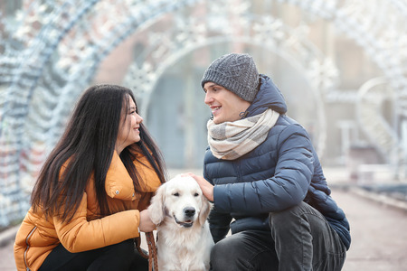 Cute couple with dog outdoors