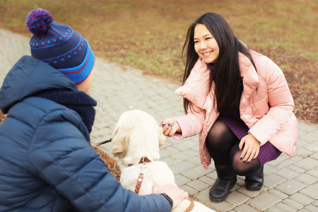 Cute couple with dog outdoorsの写真素材