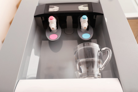 Office water cooler with glass cup, closeupの写真素材