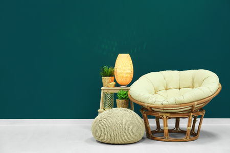 Trendy living room interior with comfortable armchair against shaded spruce wallの写真素材