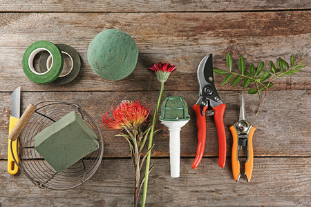Florist equipment with flowers on wooden backgroundの写真素材