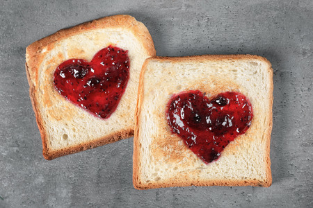 Delicious toasts with sweet jam on grey backgroundの写真素材