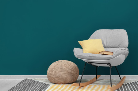 Trendy armchair near shaded spruce wallの写真素材