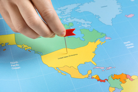 Woman pinning America on map, closeupの写真素材