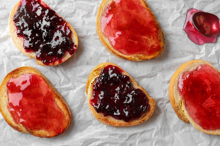 Delicious toasts with sweet jams on tableの写真素材