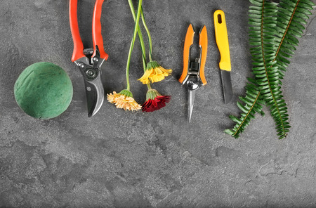 Florist equipment with flowers on grey backgroundの写真素材