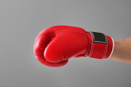 Man in boxing glove on gray backgroundの写真素材
