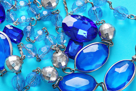 Beautiful jewellery with precious stones on color backgroundの写真素材